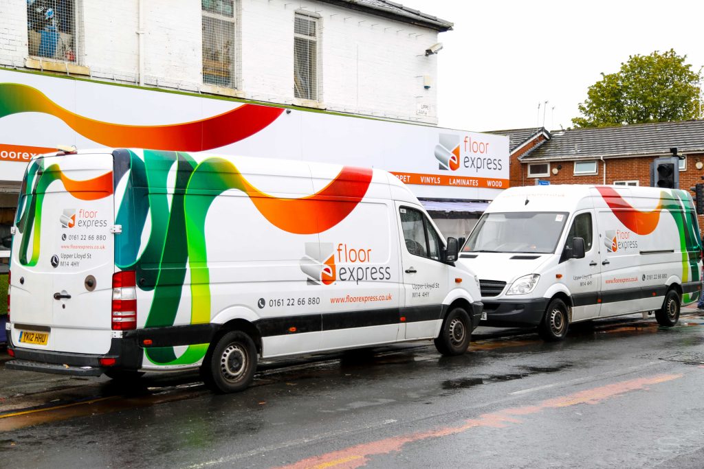 Floor Express vans outside Rusholme carpet flooring shop Manchester showing trust & expertise daily