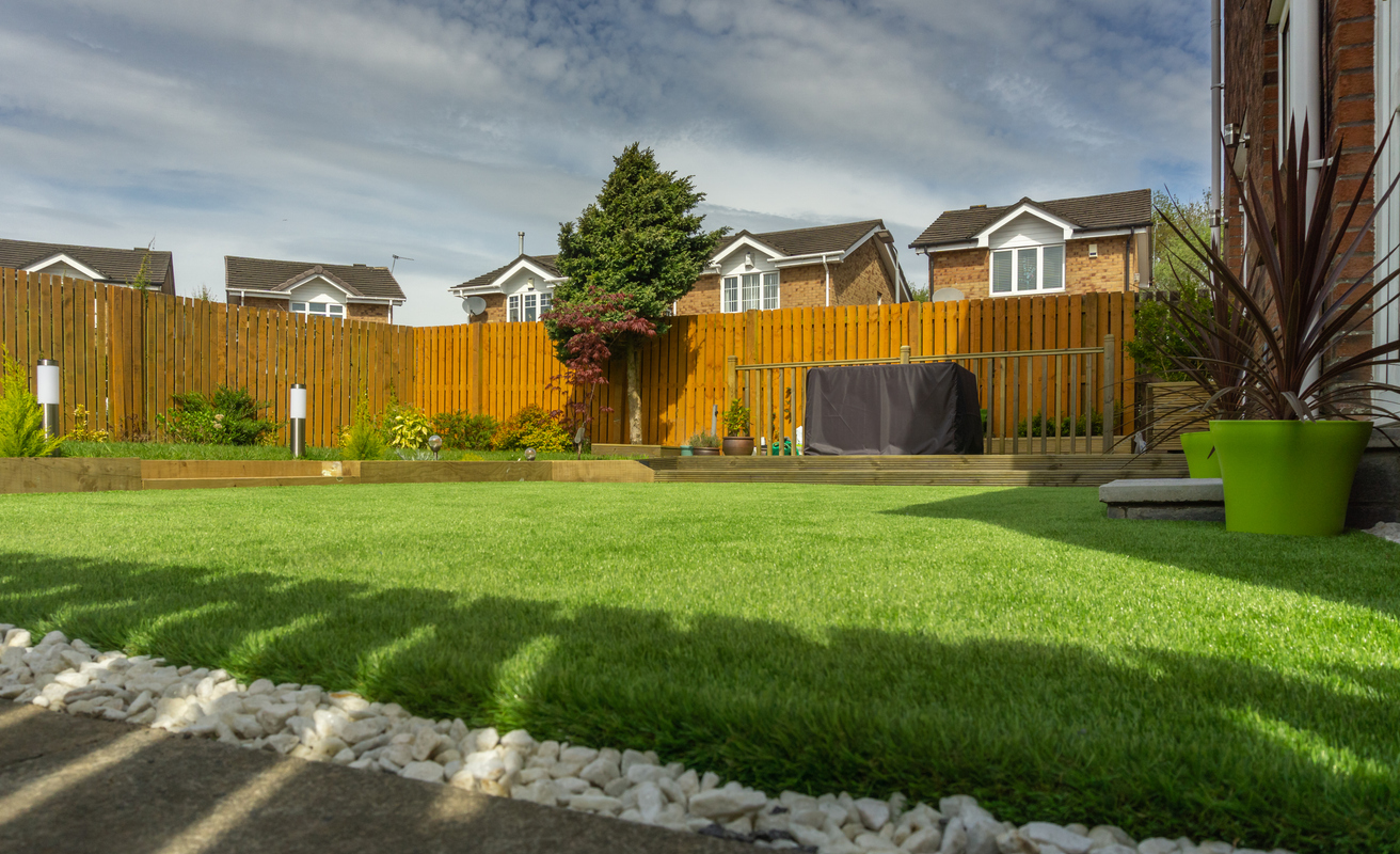 a UK back garden with an artificial grass lawn