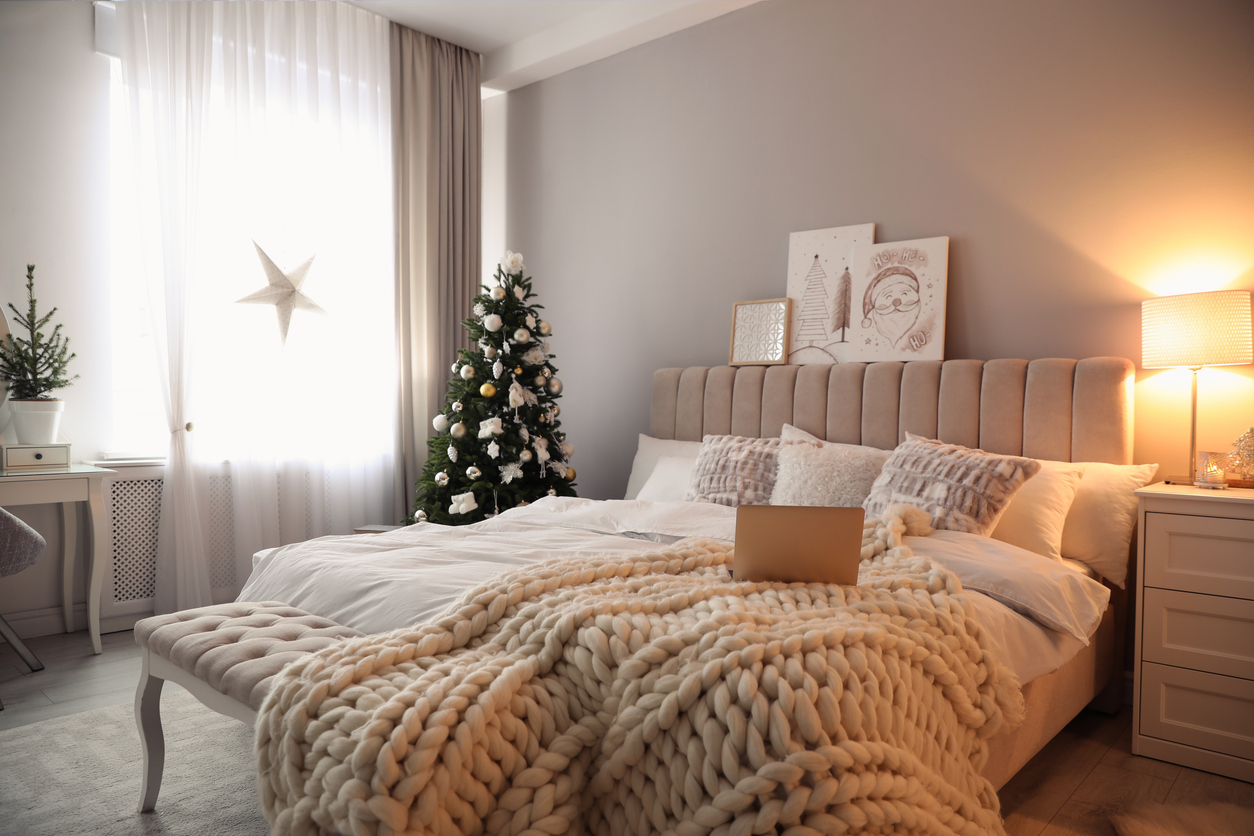 a bedroom with carpet and a christmas tree