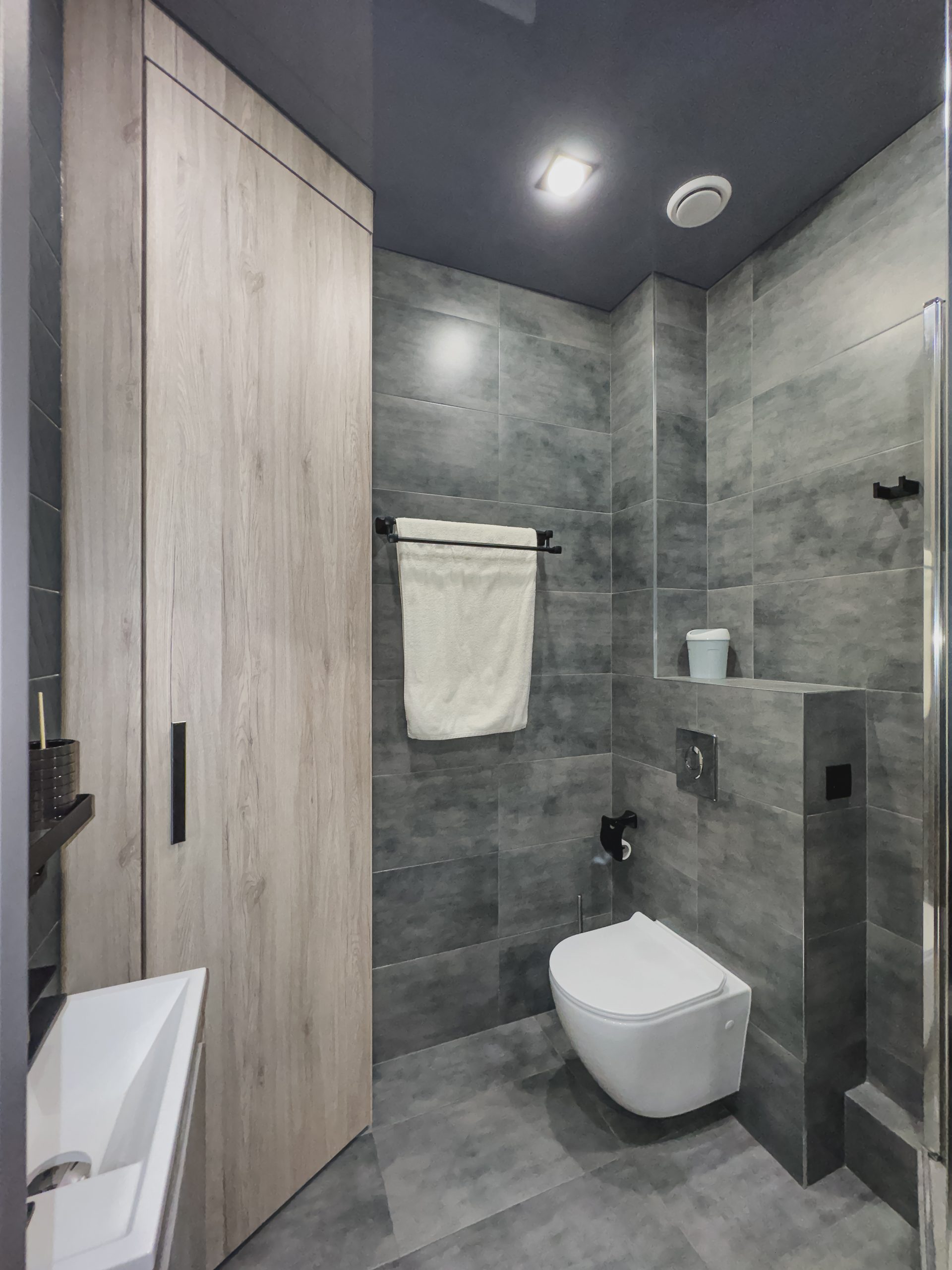 a modern bathroom with grey lino flooring