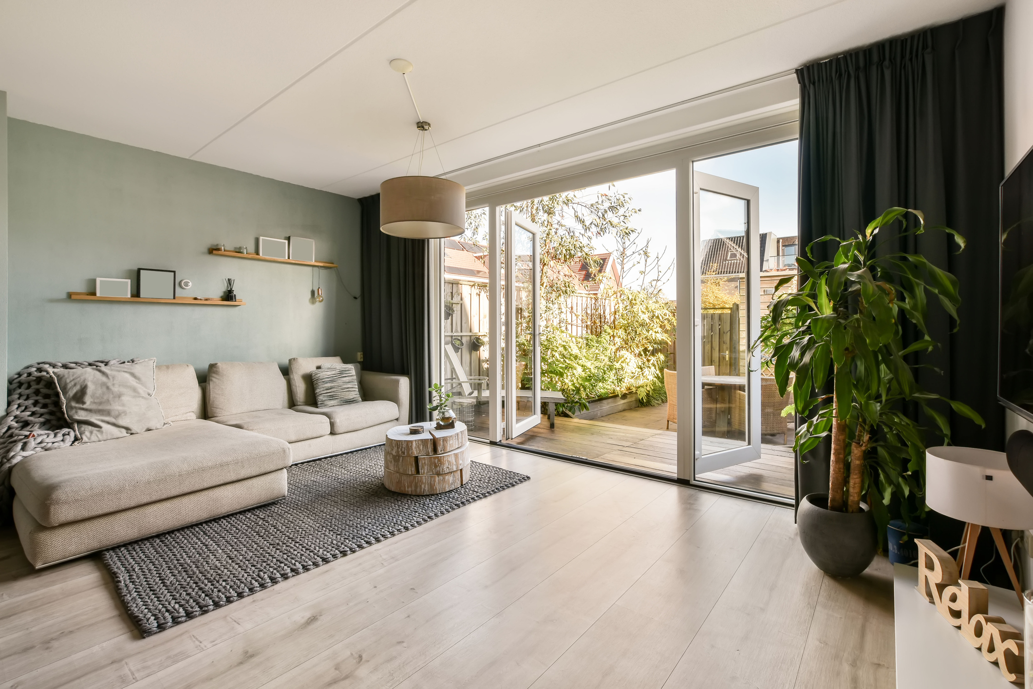 a modern living room with grey beige laminate flooring