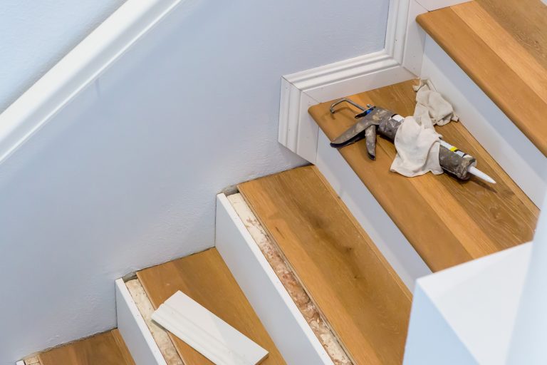 laminate flooring with stair nosing being laid on a staircase Cheap Laminate Flooring Manchester laminate flooring with stair nosing being laid on a staircase