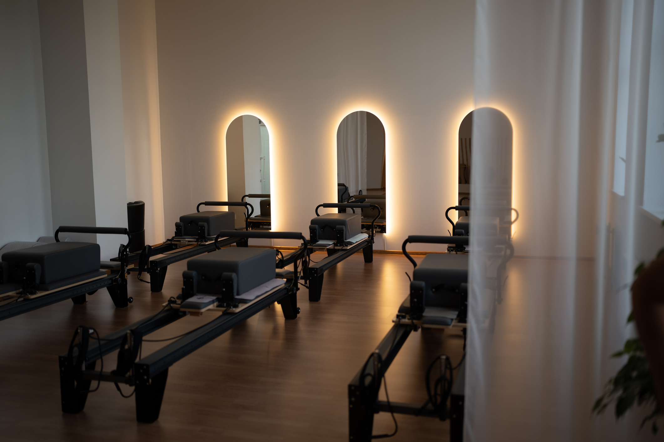 a reformer pilates fitness studio with commercial laminate floors
